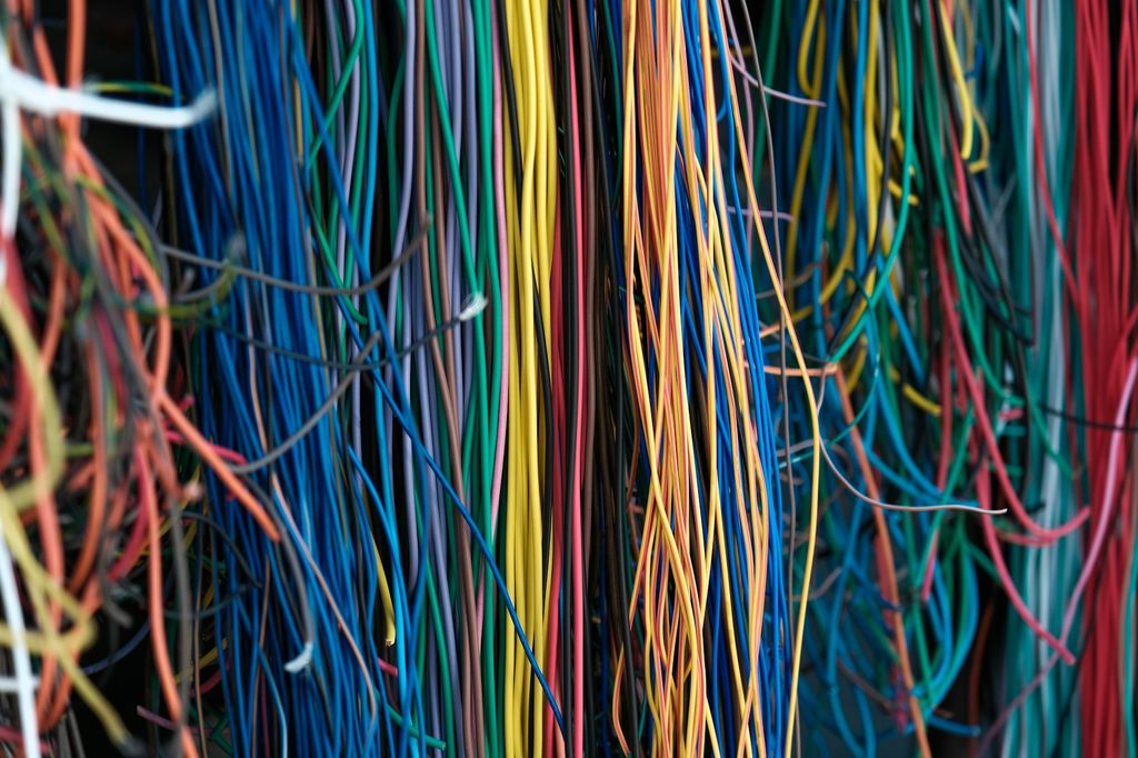 Hundreds of tangled colored wires hanging in a mess